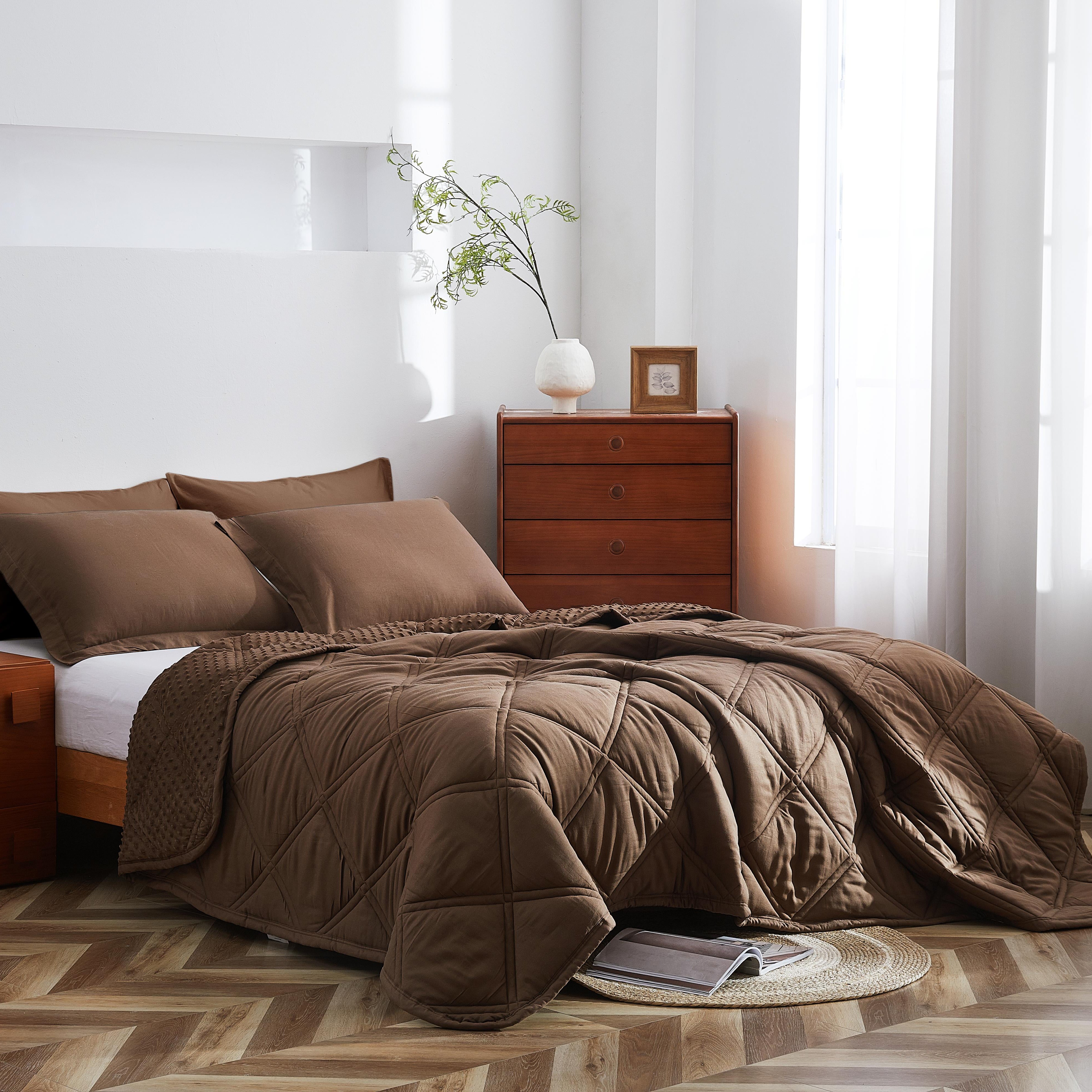Bedroom with brown comforter and wooden furniture